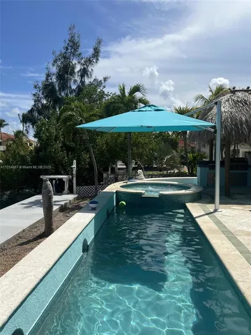 swimming pool view with a seating space