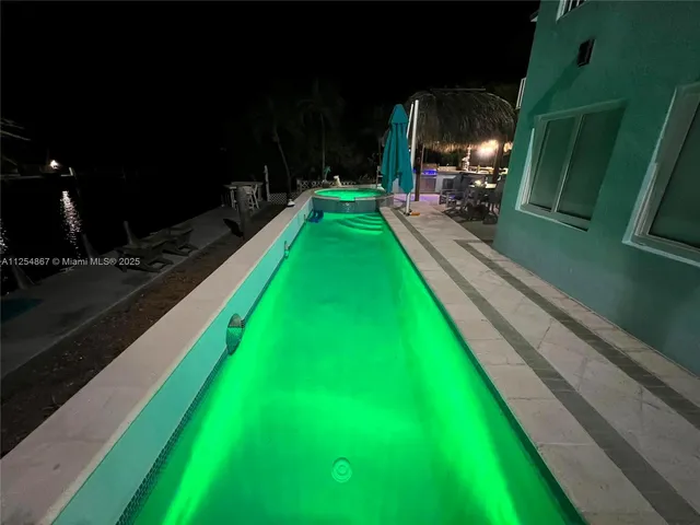 an aerial view of a house with swimming pool garden and patio