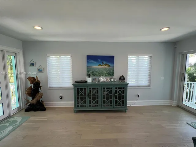 a view of a room with furniture and windows