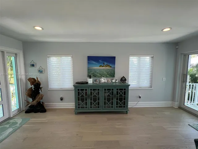 a view of a livingroom with furniture window and wooden floor