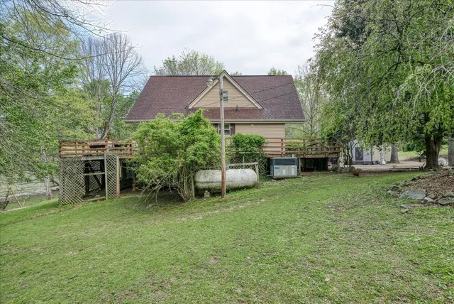 a house view with a sitting space and garden