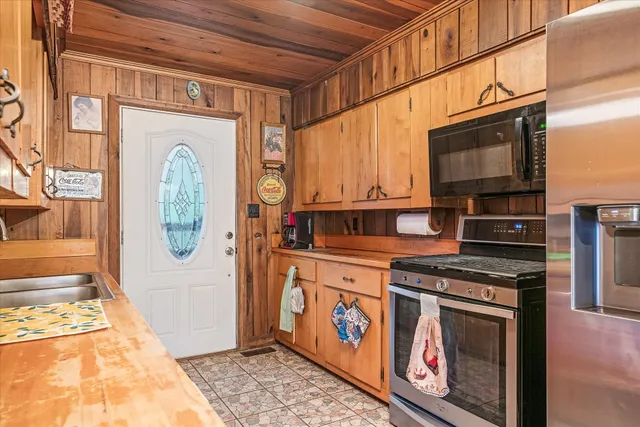 a kitchen with stainless steel appliances granite countertop a stove and a microwave