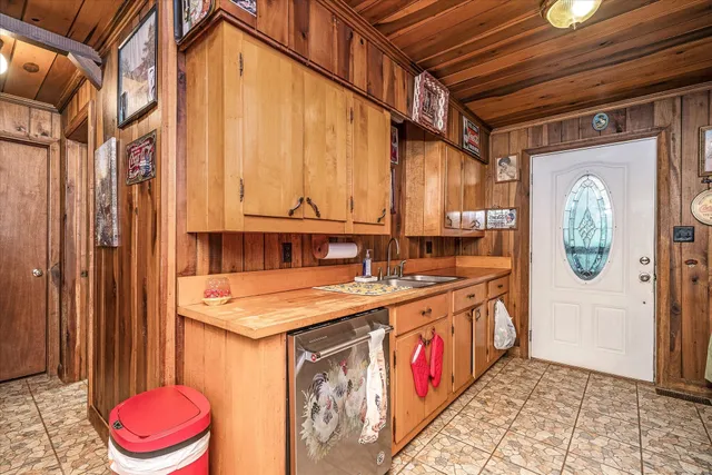 a utility room with stainless steel appliances a stove and a refrigerator