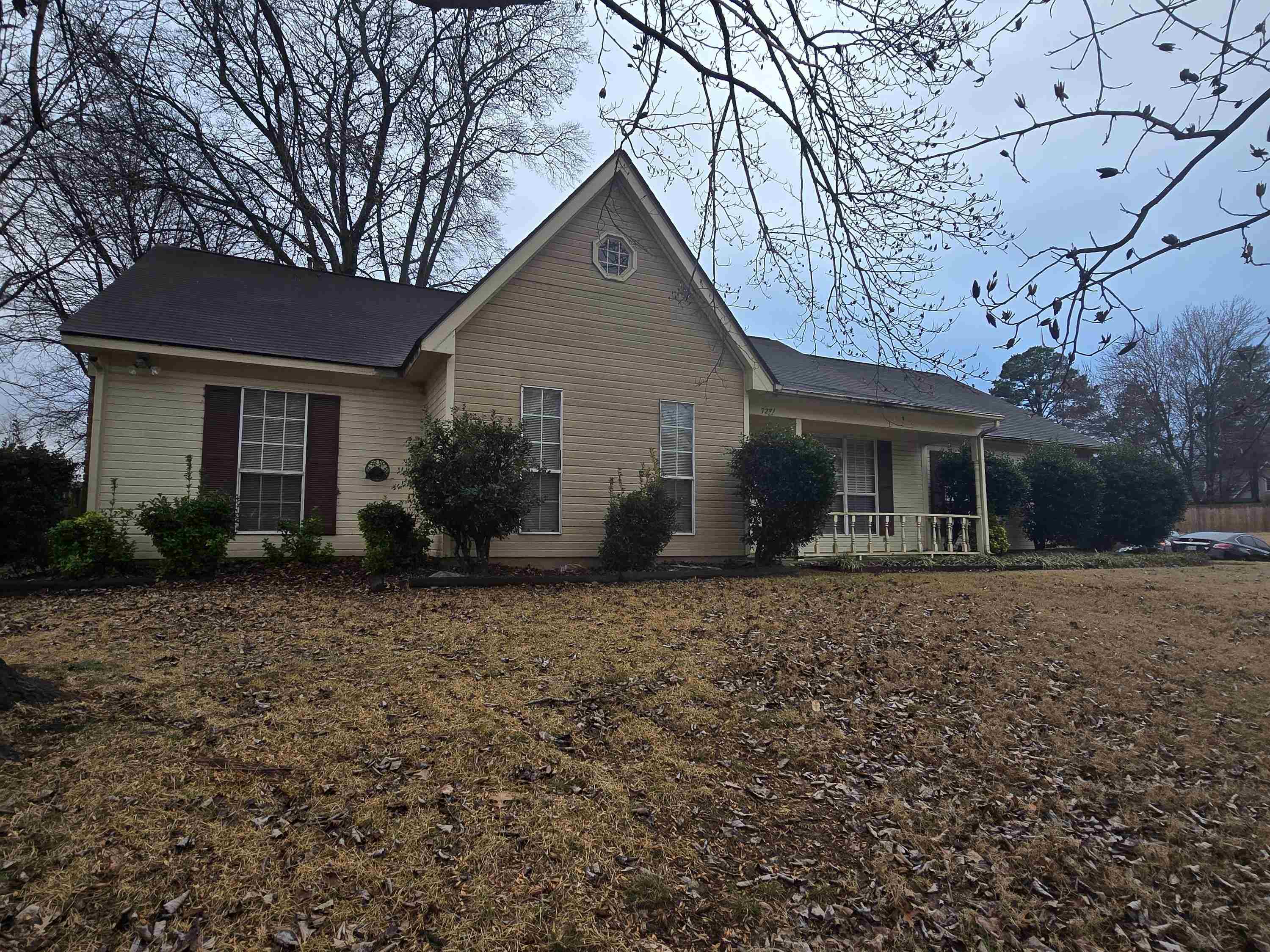 7271 Barnstable Road Memphis, TN 38125 - Photo 2 of 3 a front view of house with yard and trees around