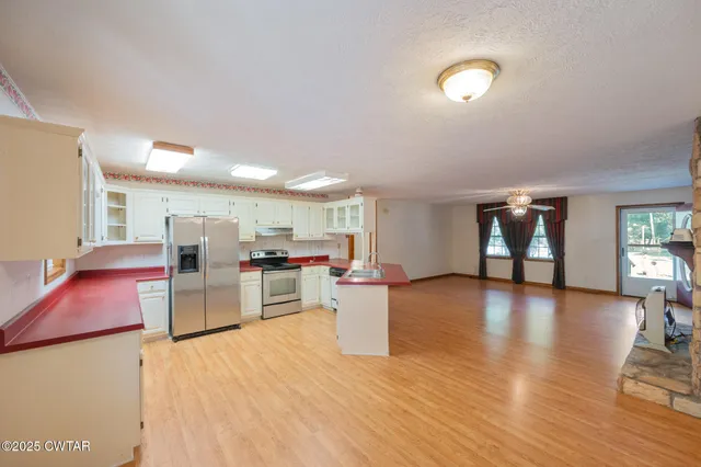 a kitchen with refrigerator and cabinets