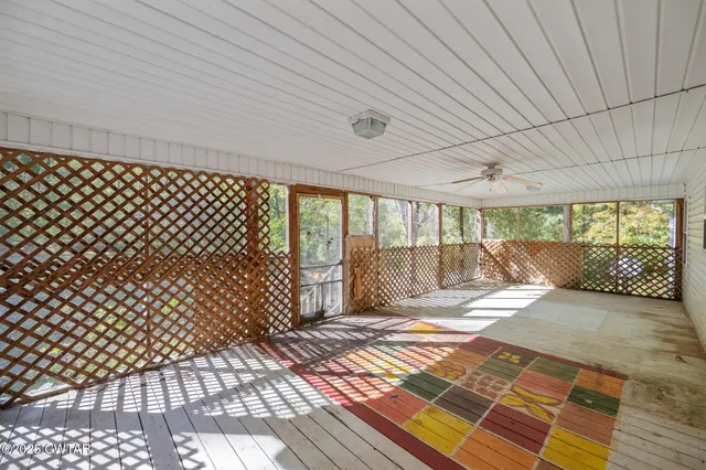 a view of a room with wooden floor and iron stairs