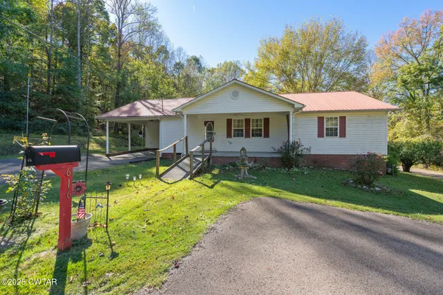 a view of a house with a yard and sitting area