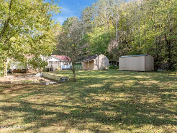 a backyard of a house with table and chairs