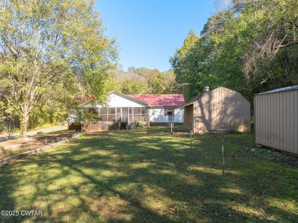 a house that has a table and chairs in front of it