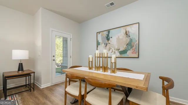 a view of a dining room with furniture and wooden floor