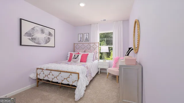 a bedroom with a bed and a painting on the wall