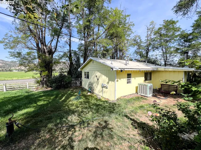 a view of a house with a yard balcony and sitting area
