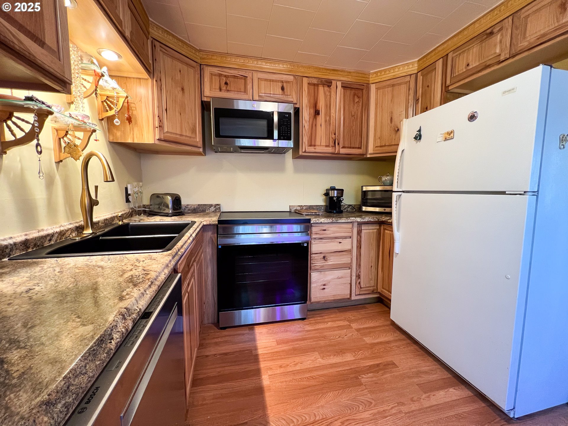 59920 Highway 26 John Day, OR 97845 - Photo 2 of 35 a kitchen with stainless steel appliances granite countertop a refrigerator a stove top oven a sink and dishwasher