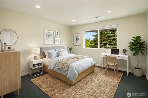 a bed room with a bed and a chair