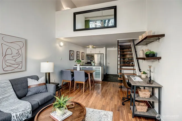 a living room with furniture and wooden floor