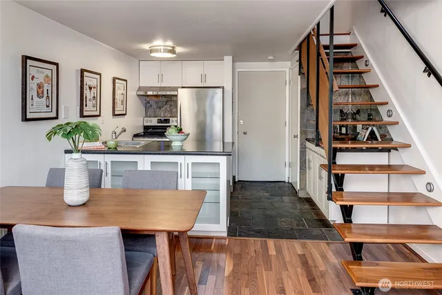 a kitchen with a table chairs and a refrigerator