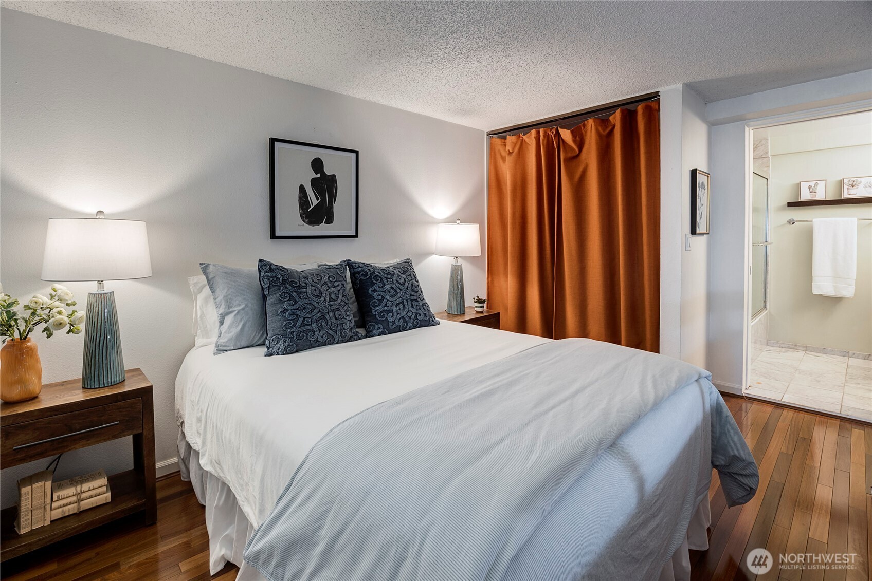 1000 Union Street, Unit 202 Seattle, WA 98101 - Photo 22 of 30 a bedroom with a bed a lamp and window