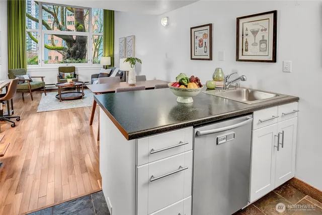 a kitchen with sink cabinets and living room