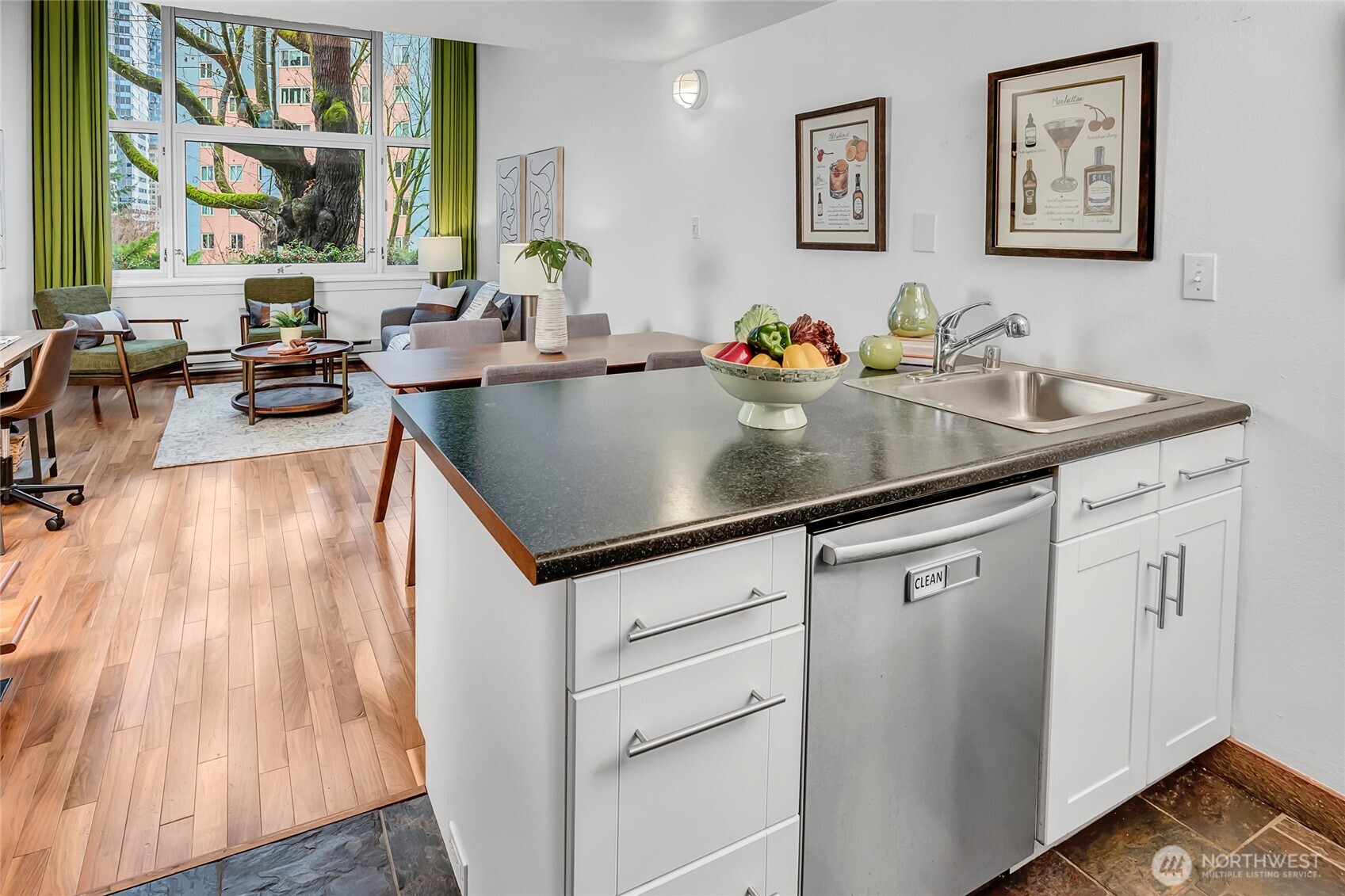 1000 Union Street, Unit 202 Seattle, WA 98101 - Photo 7 of 30 a kitchen with sink cabinets and living room