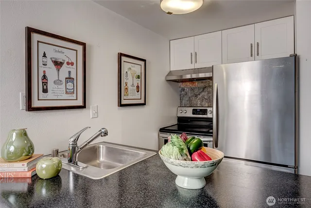 a kitchen with a refrigerator and a sink