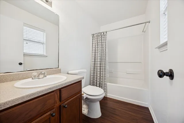 wooden floor in an empty room with a window