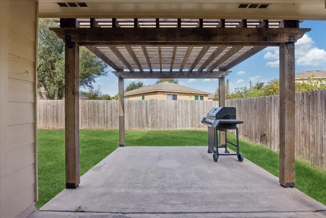 an empty room with wooden floor a ceiling fan and windows