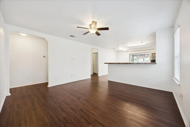 a view of a kitchen with wooden floor and a kitchen