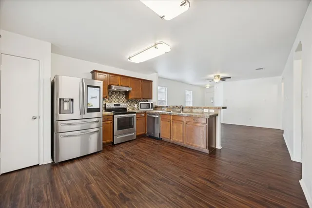 a kitchen with stainless steel appliances granite countertop a stove and a sink