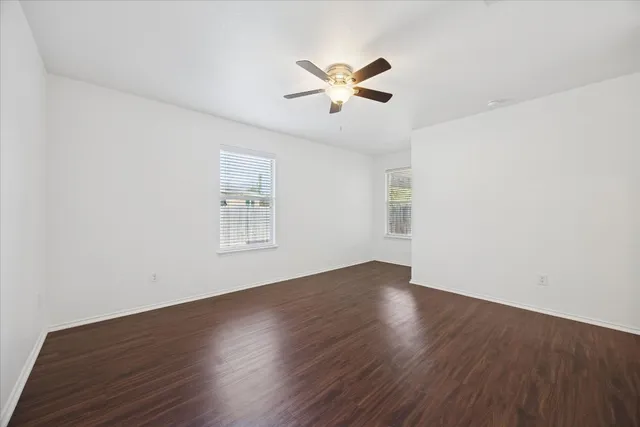 wooden floor in an empty room with a window