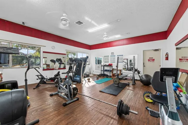 a living room with furniture a rug and a bookshelf
