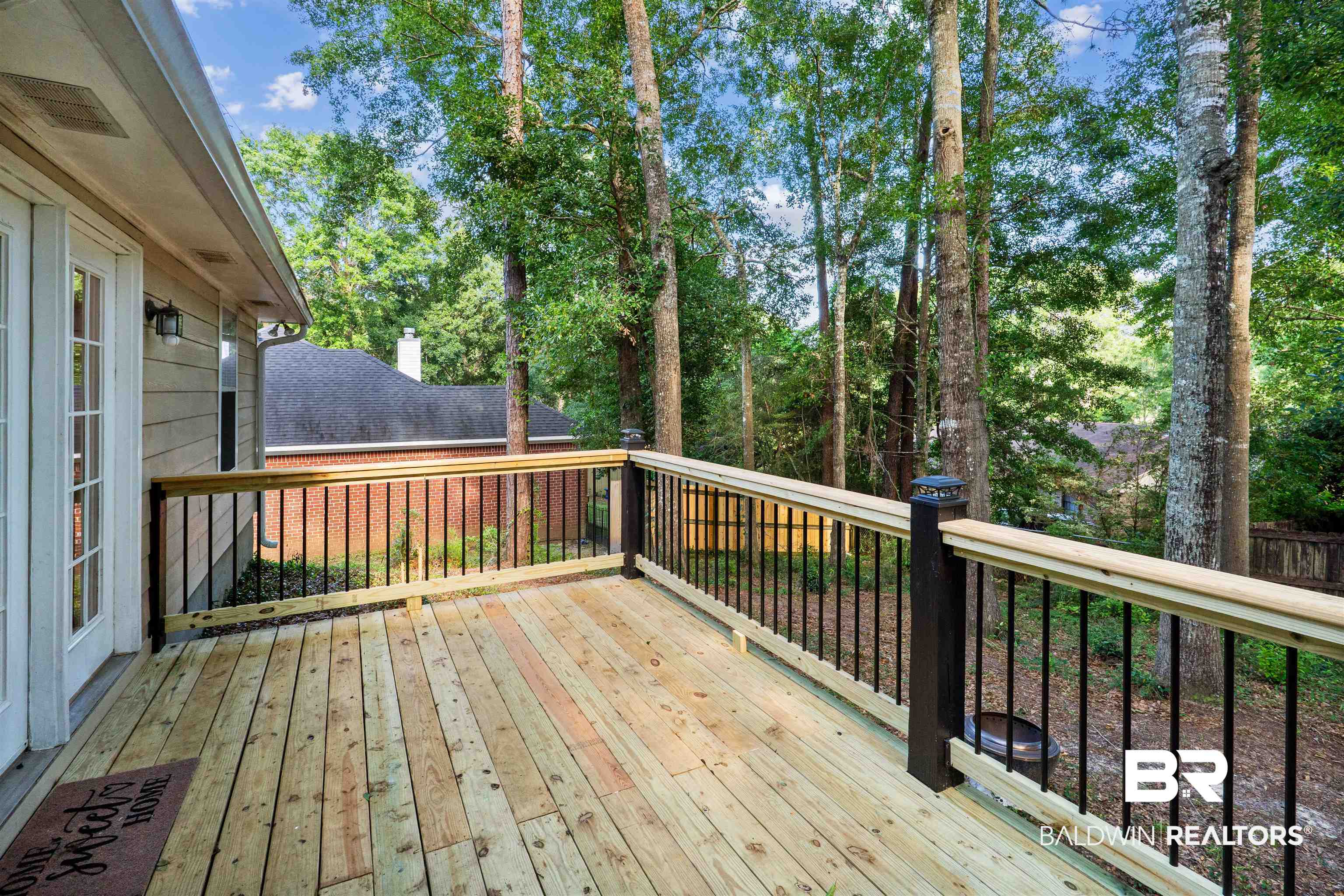 153 Lakeview Loop Daphne, AL 36526 - Photo 52 of 56 Stretch out, unwind, and enjoy the outdoors from this spacious deck overlooking the backyard setting.