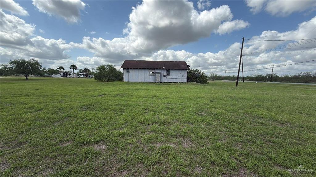 12427 Sasha Drive Santa Rosa, TX 78593 - Photo 3 of 17 a view of a big house with a big yard and a large tree