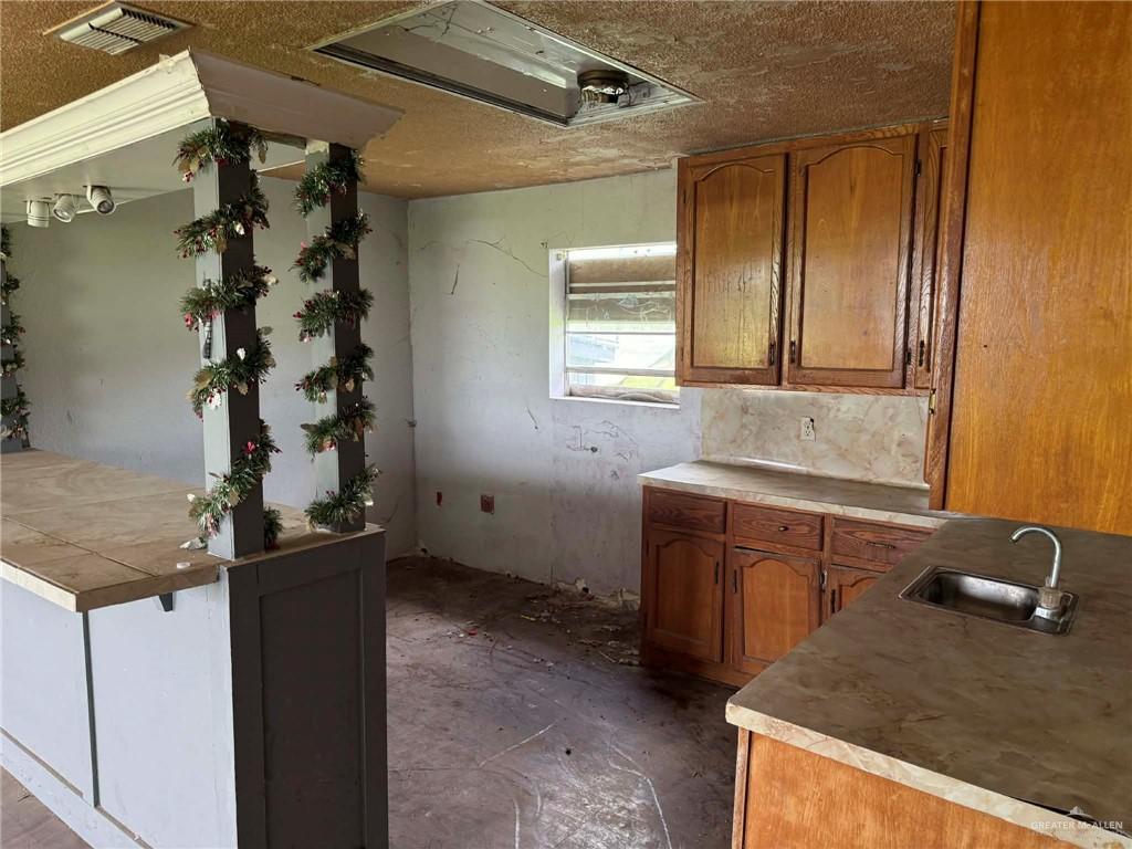 12427 Sasha Drive Santa Rosa, TX 78593 - Photo 10 of 17 a bathroom with a granite countertop sink a mirror and shower