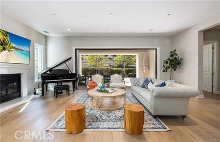 112 Gardenview Irvine, CA 92618 - Photo 11 of 33 a living room with furniture a fireplace and a flat screen tv