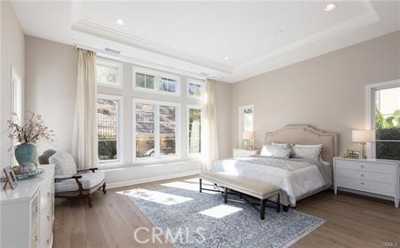 112 Gardenview Irvine, CA 92618 - Photo 13 of 33 a bedroom with a bed and wooden floor