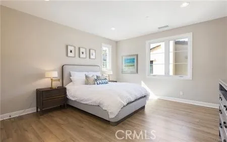 a bedroom with a bed lamp and a window