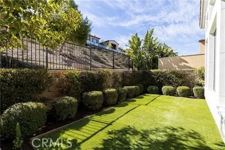 a view of a backyard with plants and a patio