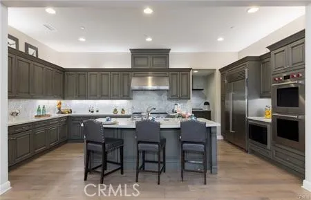 a kitchen with granite countertop a sink stainless steel appliances and cabinets