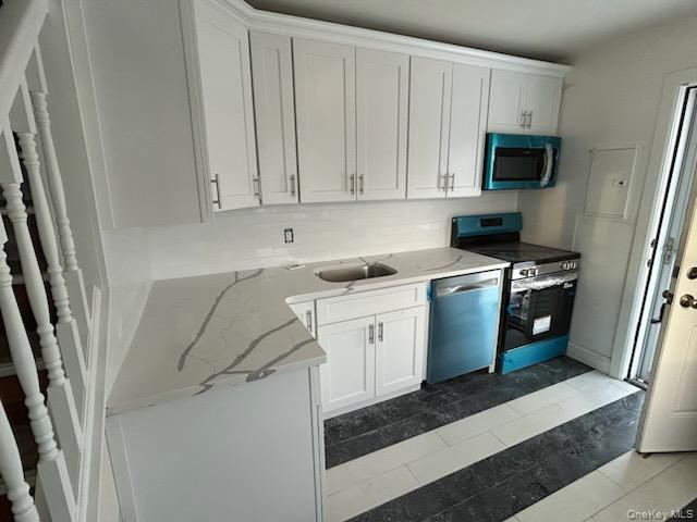 3037 North Jerusalem Road Levittown, NY 11756 - Photo 2 of 2 Kitchen featuring white cabinets, appliances with stainless steel finishes, light stone countertops, and electric panel