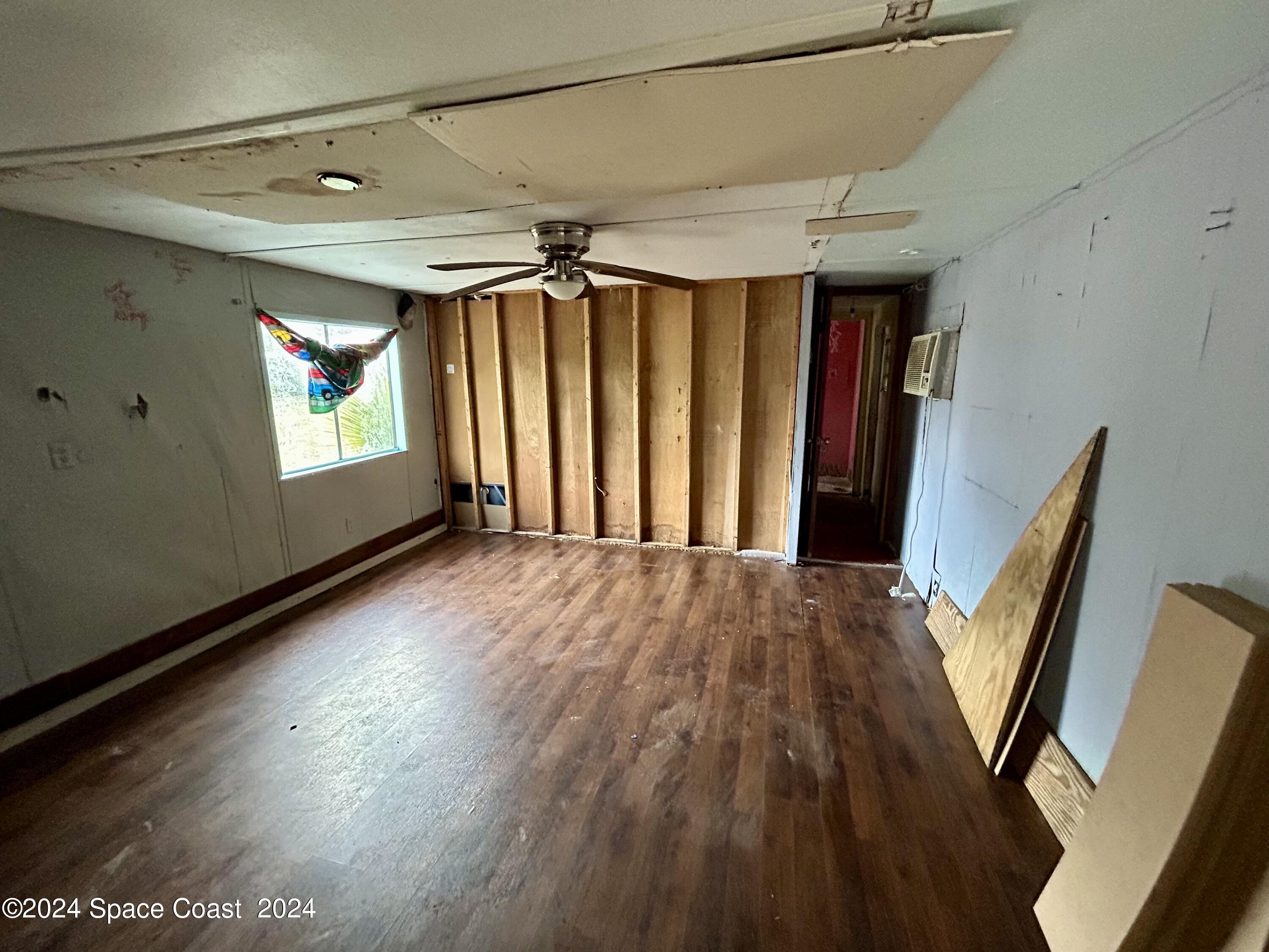 326 Iris Street Cocoa, FL 32927 - Photo 22 of 46 a view of empty room with wooden floor and fan