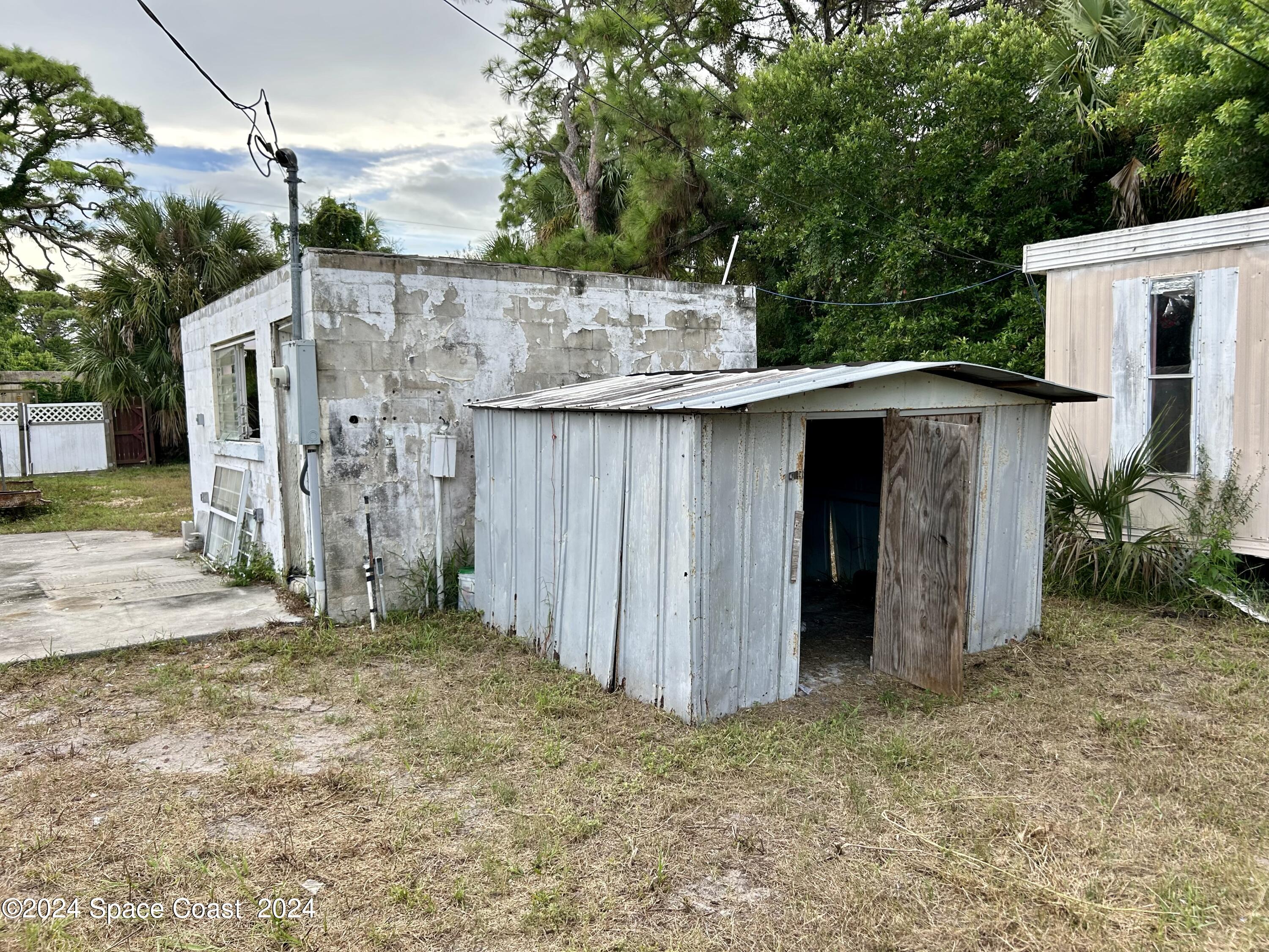 326 Iris Street Cocoa, FL 32927 - Photo 24 of 46 a view of a barn in the middle of a yard