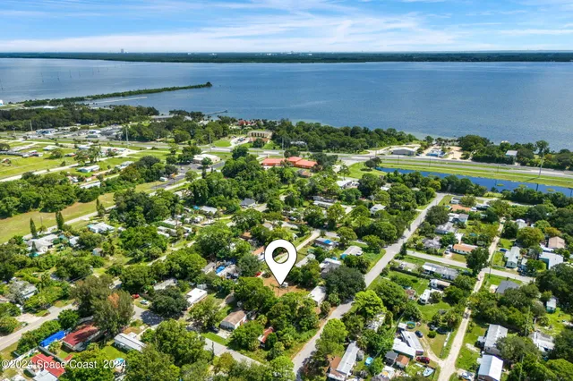 an aerial view of a house with a yard