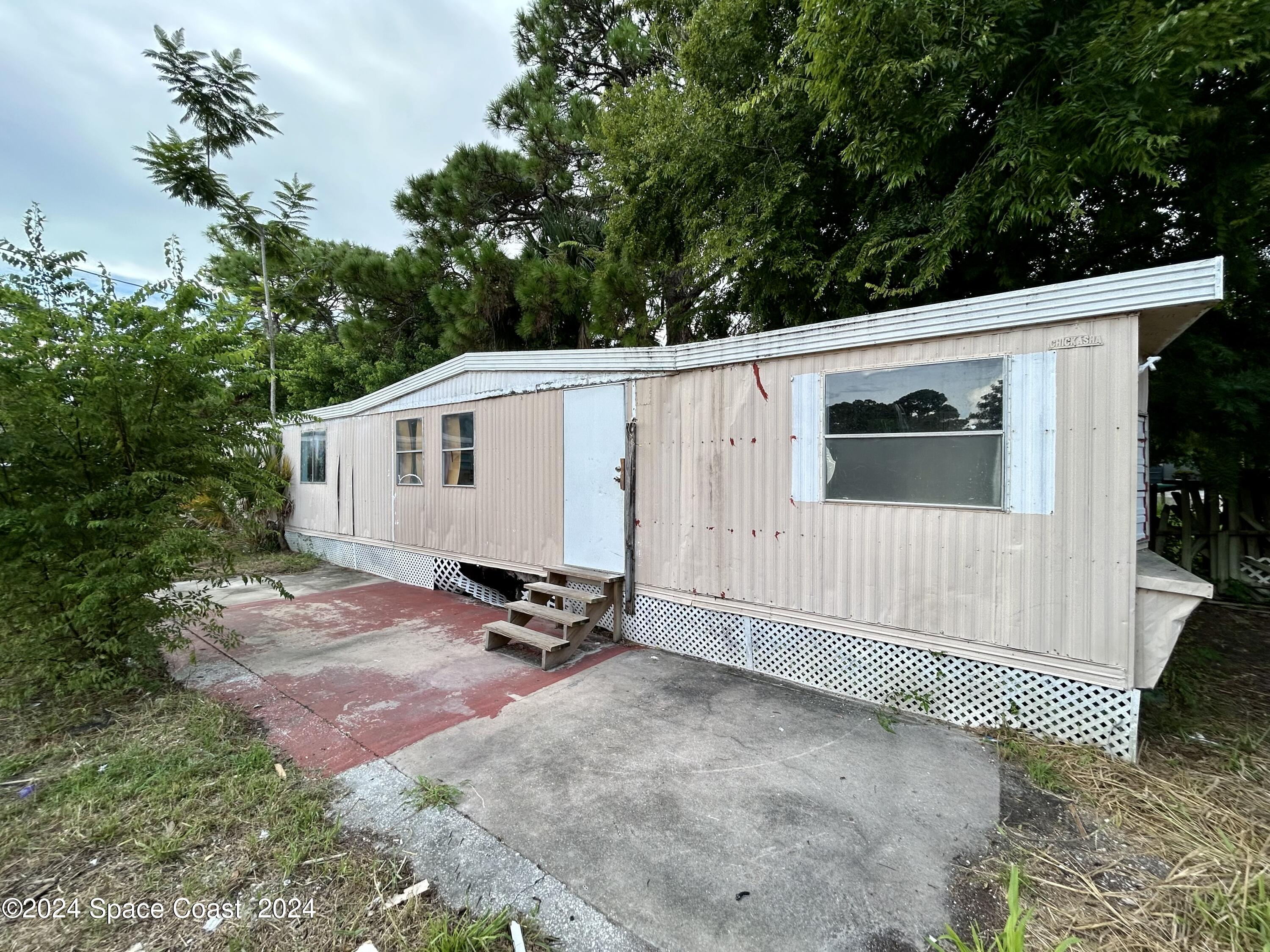 326 Iris Street Cocoa, FL 32927 - Photo 9 of 46 a view of backyard with a barn and a cactus plant