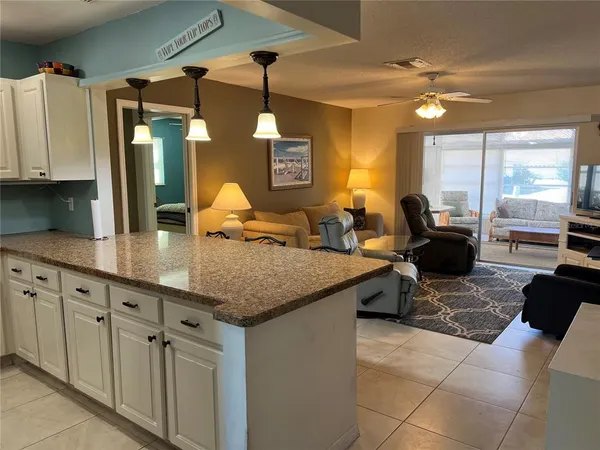 a kitchen with cabinets table and chairs
