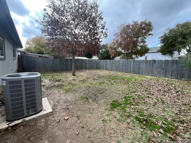 a view of yard with wooden fence