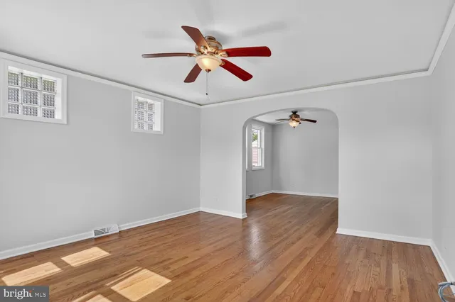 a view of empty room with wooden floor
