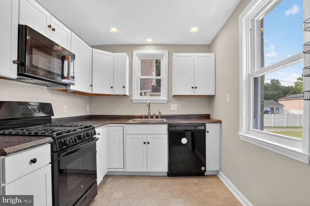 a kitchen with stainless steel appliances granite countertop a stove and a microwave