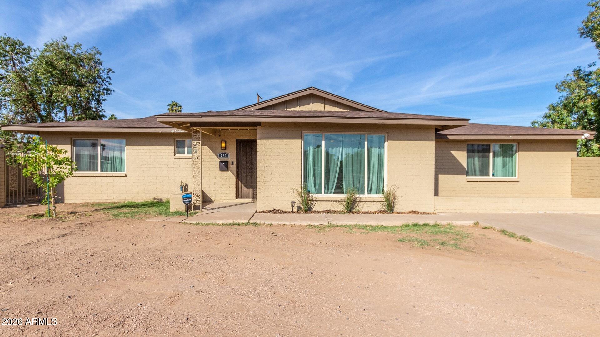860 West McLellan Road Mesa, AZ 85201 - Photo 22 of 26 a view of a house with a patio and a yard