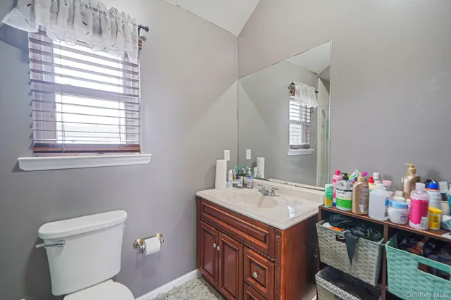 a bathroom with a sink toilet and a mirror