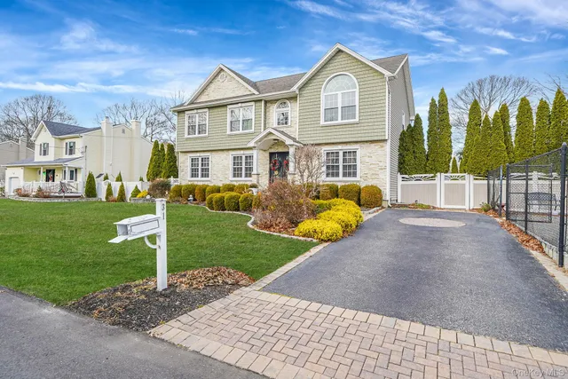 a front view of house with yard and green space